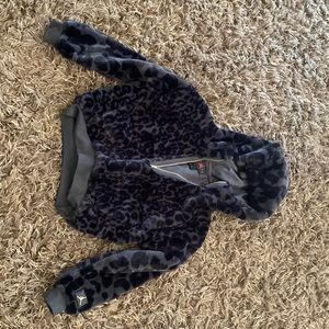 Bord cote, nylon, spandex,  and polyester. Cropped quarter zip.